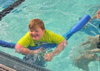 Boy with down syndrome swimming